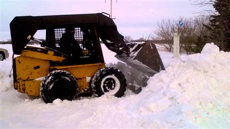 towing a stuck new holland skid steer on snow|drag a skid steer without running.